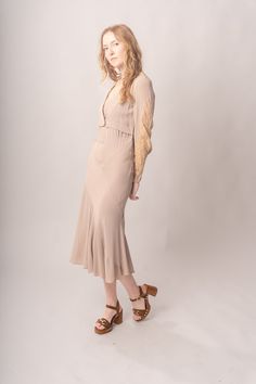 Stunningly preserved 1920’s mauve & ecru bias cut dress with attached jacket, lace trim, and asymmetrical cut. Best fits modern size S-M Length 52”Pit to pit 18.5”Waist 26-30”Hips 31-42” Model’s Measurements:Height 5’9”Chest 34”Waist 29”Hips 36.5” Excellent vintage condition, with normal wear and condition for its age.For international shipping rates, please send inquiries to our CONTACT page. Fitted Viscose Midi Dress With Bias Cut, Fitted Bias Cut Viscose Midi Dress, Fitted Bias Cut Midi Dress For Daywear, Fitted Rayon Dress For Fall, Fitted Rayon Dresses For Fall, Fitted Lace Trim Midi Dress For Fall, Fitted Rayon Dresses With Bias Cut, Fitted Rayon Dresses In Bias Cut, Fitted Bias Cut Dresses In Rayon