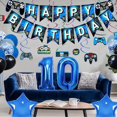 a blue couch sitting under a happy birthday banner