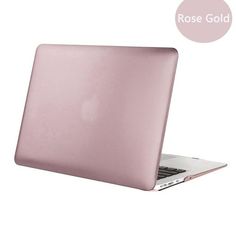 an open laptop computer sitting on top of a white surface with a rose gold sticker