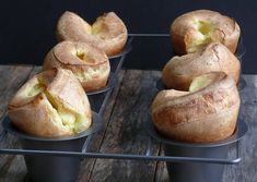 some baked goods are sitting in tins on a table