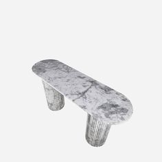 a marble bench sitting on top of a white floor