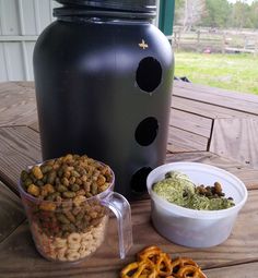 some food that is sitting on a table next to a large black container and bowl