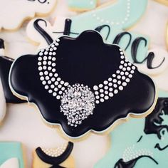 decorated cookies with black and white icing are displayed in front of the word love