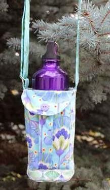 a purple and blue bottle hanging from a tree