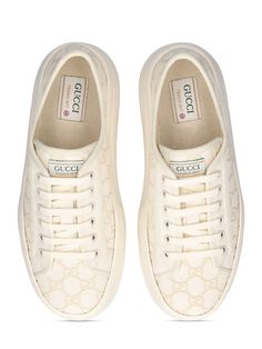 52mm Heel. Off-white canvas with GG embroidered upper. Off-white trim. Front lace-up closure. Logo details. Gucci Tennis 1977 label . All over pattern placement may vary. Rubber platform sole. Includes additional pair of laces All Over Pattern, Ski Accessories, Mule Sandals, Flat Espadrilles, Swim Accessories, Heeled Loafers, Shearling Jacket, White Trim, White Canvas