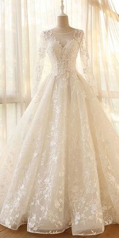 a white wedding dress on display in front of a window