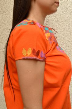 Blouse multicolored handmade by Mexican artisans. . It is important to mention that absolutely all the process is done by hand, so the size, shape and color can varybetween pieces. . Measurements:↕ 26 in↔ 20 6/7 in Traditional Orange Cotton Tops, Orange Embroidered Cotton Blouse, Orange Cotton Blouse With Floral Embroidery, Traditional Multicolor Cotton Embroidered Top, Orange Embroidered Festival Tops, Artisan Multicolor Cotton Top, Orange Embroidered Tops For Festival, Festival-style Orange Embroidered Tops, Multicolor Embroidered Cotton Blouse