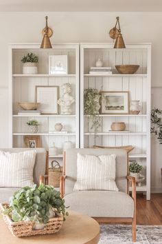 a living room filled with furniture and lots of plants on top of bookshelves