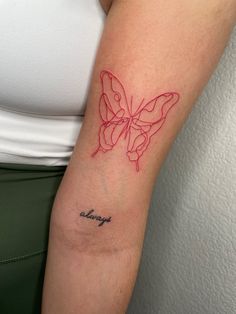 a woman's arm with a butterfly tattoo on the left side of her arm