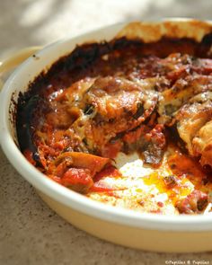 a casserole dish with meat and cheese in it