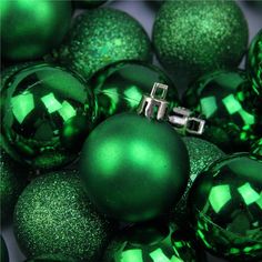 green christmas balls with silver cross on them