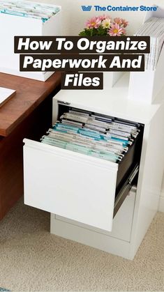 an office desk with two file cabinets and a flower pot on the table next to it