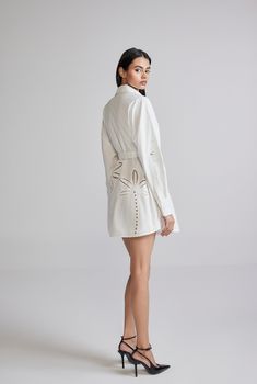 The Lani White Short Shirt Dress is an ethereal breezy style from the Resort'24 Collection. Armed with the versatility of white and the comfort of cotton poplin, the dress features Battenburg lace embroidery, a shirt collar with a button-down closure., and full sleeves with a cuff. Oozing casual elegance, the dress gently curves at the hem and cinches at the waist with a tie-up belt. A perfect style for champagne brunches! Made In India White Embroidered Cotton Poplin Shell - 100% Cotton Curved Feminine White Shirt Dress For Daywear, Elegant White Shirt Dress For Spring, White Button-up Feminine Shirt Dress, White Feminine Button-up Shirt Dress, White Cotton Shirt Dress For Spring, Feminine Summer Button-up Shirt Dress, White Feminine Shirt Dress For Spring, White Spread Collar Dress For Daywear, White Shirt Dress For Spring