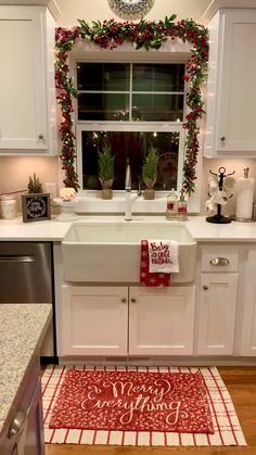 a kitchen decorated for christmas with red and white decor