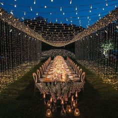 a long table is set up with candles and lights for a dinner in the dark