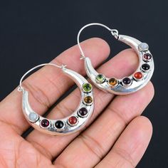 Half Moon Seven Chakra Gemstone Earrings | 925 Sterling Silver | Mediation Chakra Earrings |  Silver Earrings for Women & Girls Seven Chakra Gemstone Stone Creation- Natural Metal - Silver  Earrings Welcome to our little shop, where you can find  silver jewelry and more, for you and your loved ones. We do accept custom orders also, kindly message us for more. Note :- Due to the natural formation of this gemstone. Slight variation in texture and color but stone shape is same. Benefits of Wearing Fusion Style Sterling Silver Hoop Earrings As Gift, Bohemian Silver Gemstone Crystal Earrings, Silver Dangle Hoop Earrings With Natural Stones, Bohemian Silver Crystal Earrings With Gemstones, Silver Crystal Earrings With Natural Stones, Silver Sterling Crystal Earrings With Natural Stones, Handmade Silver Crystal Hoop Earrings, Adjustable Silver Crystal Gemstone Earrings, Silver Natural Stones Fusion Earrings