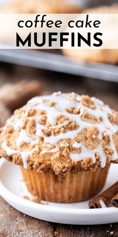 coffee cake muffins with icing on a white plate next to cinnamon sticks