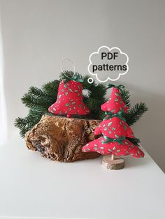 three red christmas trees sitting on top of a tree stump with a thought bubble above them