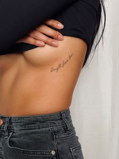 the back of a woman's stomach with writing on it that says, strength is love