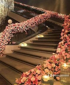 the stairs are decorated with flowers and candles for an elegant wedding or special event venue