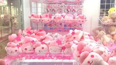 there are many pink stuffed animals on display