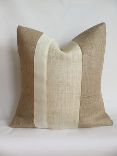 a beige and white striped pillow on a white background with a black stripe down the side