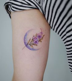 a woman's arm with a flower tattoo on the left side of her body