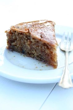 a piece of cake sitting on top of a white plate next to a knife and fork