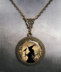 "Witch and Raven Art Nouveau necklace ~ A beautiful and unique bit of Halloween art, perfect for your Elvira outfit.  The glass pendant is set into a necklace featuring a beautifully detailed reproduction of an Art Nouveau connector and it's a great gift for your favorite witch or Wiccan.  The pendant measures 1-3/16\" across (30mm) and the artwork is covered by a crystal clear, domed glass cabochon which protects and enhances the image for a truly beautiful effect!  The necklace closes with a l Gold Fantasy Costume Jewelry, Fantasy Costume Jewelry For Halloween, Fantasy Halloween Costume Jewelry, Halloween Nickel Free Pendant Necklace, Halloween Nickel-free Pendant Necklace, Nickel-free Pendant Necklace For Halloween, Witchy Jewelry For Halloween Jewelry Making, Bronze Fantasy Necklace For Gifts, Bronze Fantasy Necklace For A Gift