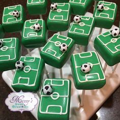 soccer themed cupcakes are arranged in the shape of squares with balls on them