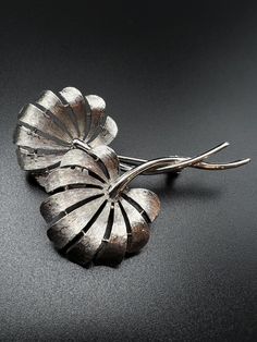 Add a touch of vintage charm to your outfit with this beautiful brooch pin by J&J. The silver-toned brooch features a leaf shape, making it perfect for nature lovers. It is versatile enough to be worn on various occasions. The brooch is a fashion accessory that will never go out of style, and this one is no exception. Its intricate details and timeless design make it a must-have for both men and women. This piece, in particular, is vintage and signed by J&J, adding extra value to its uniqueness. It measured at 2.5" x 2".   Shop more items: https://www.etsy.com/shop/FayeVonTreasuresLLC (106) Leaf Shapes, Jewelry Lover, Leaf Design, Vintage Signs, Vintage Watches, Vintage Charms, Vintage Silver, Jewelry Stores, Brooch Pin