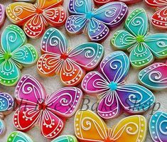 many colorful butterflies on a white surface