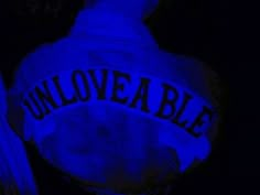 an unloveable hoodie is lit up in the dark with blue light