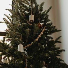 a small christmas tree with ornaments hanging from it