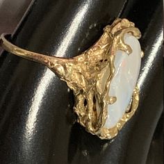 This modernist nugget style 14K yellow gold ring sports a fantastic marquis cut fire opal with amazing flash, fire, and color. Beautiful design and in excellent vintage condition. The opal measures approximately 20mm X 12mm. Ring size 10, but could be sized down. Appraisal value is $2400.00. As with all my pricier items, I am happy to set up a payment plan that fits your budget. Collectible Gold Opal Rings, Collectible Opal Ring In 14k Gold, Natural Fire Opal Ring, Fire Opal Engagement Ring 1stdibs, Antique Multi-stone Yellow Gold Opal Ring, Mexican Fire Opal Ring, Beaded Flapper Dress, Magical Dress, Satin Wedding Gown