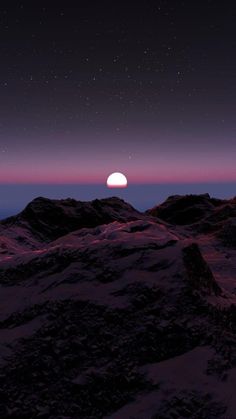 the moon is seen over some mountains at night, with stars in the sky above