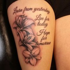 a woman's thigh with flowers on it and the words learn from yesterday live for today hope for tomorrow