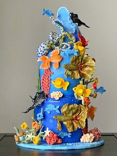 a blue cake decorated with fish and corals