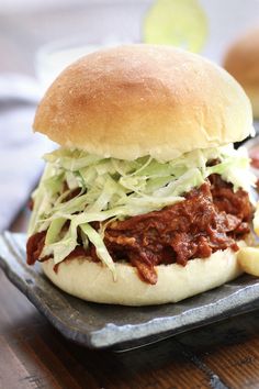 a pulled pork sandwich with coleslaw on a bun