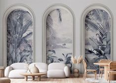 a living room filled with furniture and wall murals