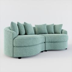 a curved sectional sofa with pillows on the top and bottom corner, in light blue