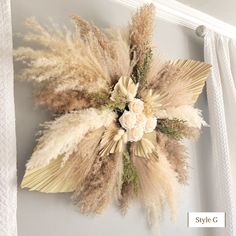 a wall decoration with dried flowers and leaves