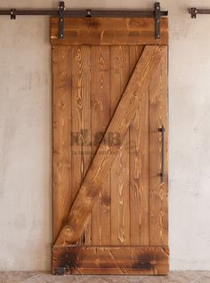 an open wooden door in front of a white wall