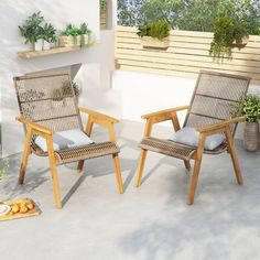 two wooden chairs sitting on top of a patio