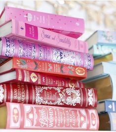 a stack of books sitting on top of a white shelf next to a pile of other books