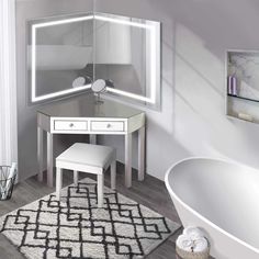 a bathroom with a white vanity, mirror and bathtub next to a large window