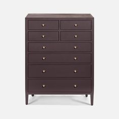 the chest of drawers is brown and has gold knobs on each drawer's sides