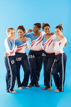 the u s women's gymnastics team poses for a photo in their olympic uniforms