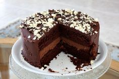 a chocolate cake with frosting and sprinkles