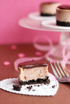 a piece of cake sitting on top of a white doily next to a fork